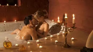 A stunning blonde enjoys a steamy bath with soft lighting and intense passion, tagged with sensuality, beauty, and love.